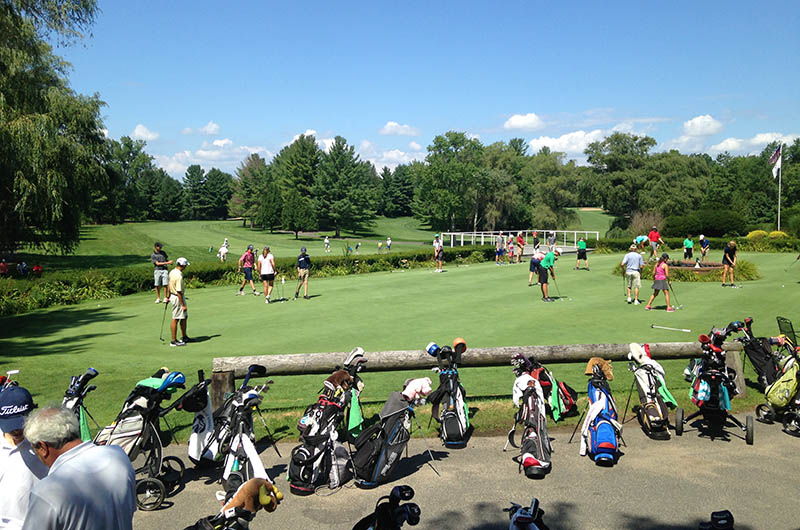 golfers practicing around the putting area